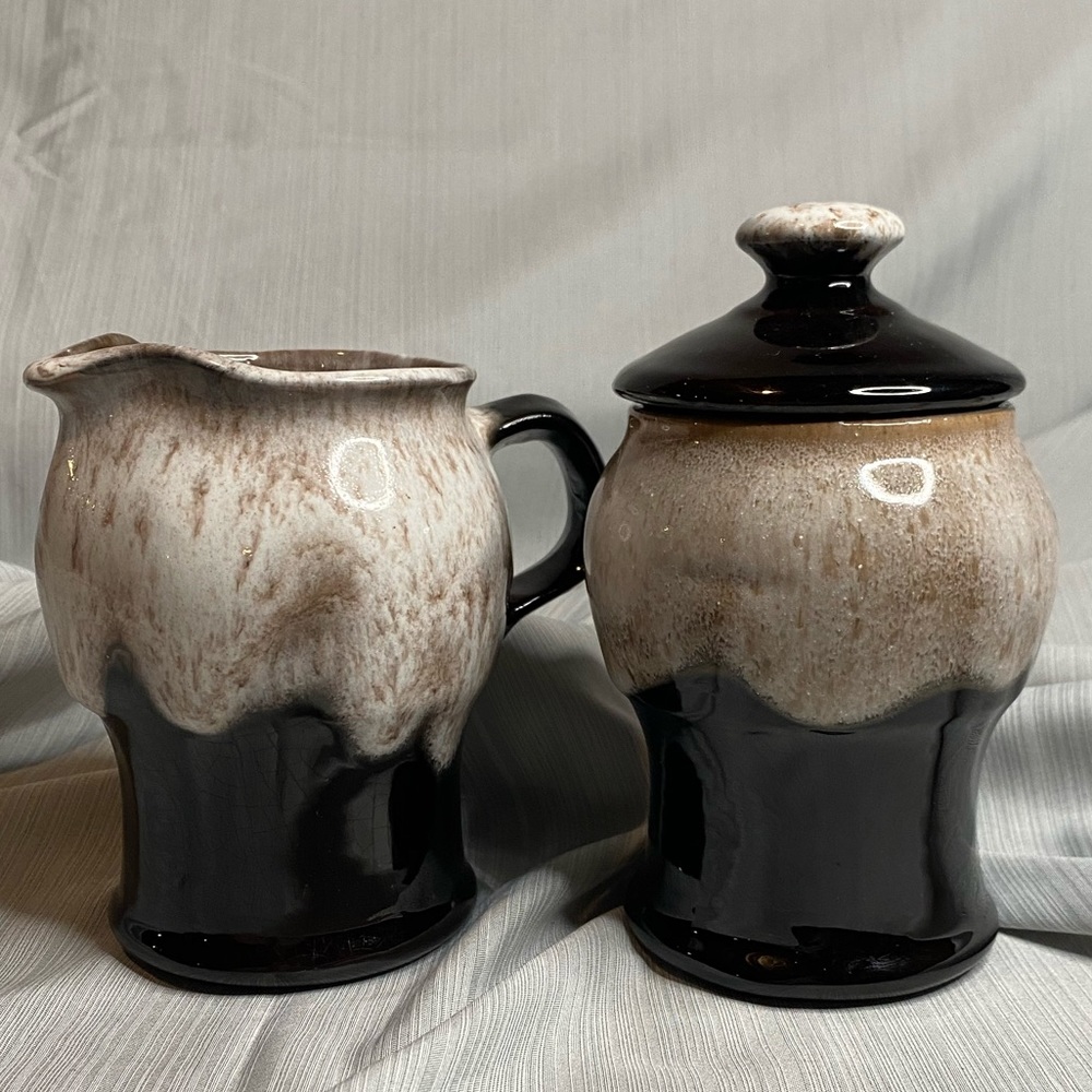Art pottery glazed sugar bowl and creamer.